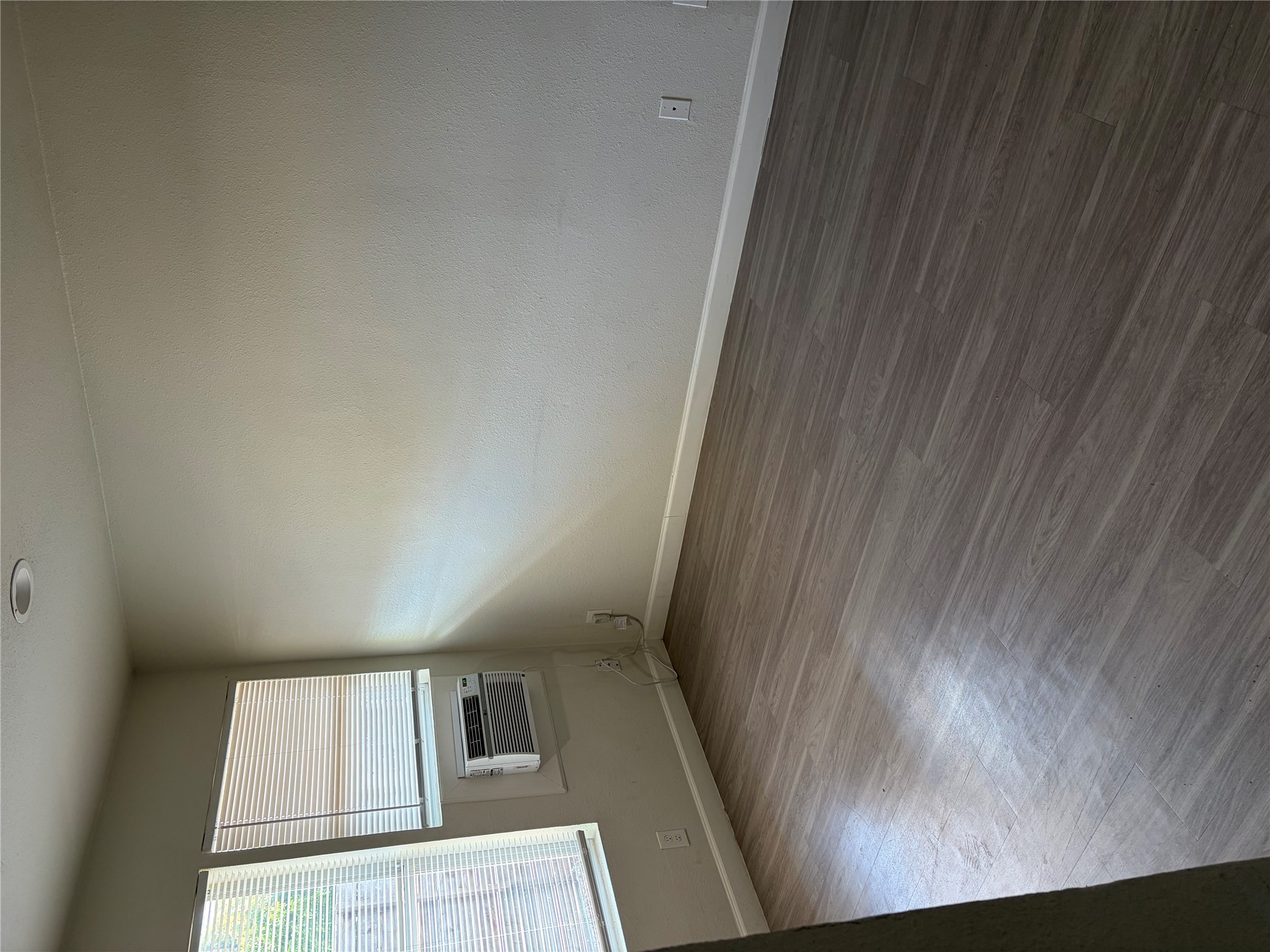 4501 Speedway, Unit 101 Austin, TX 78751 - Photo 6 of 7 Wood-look flooring and ample windows define this ready-to-personalize interior space.