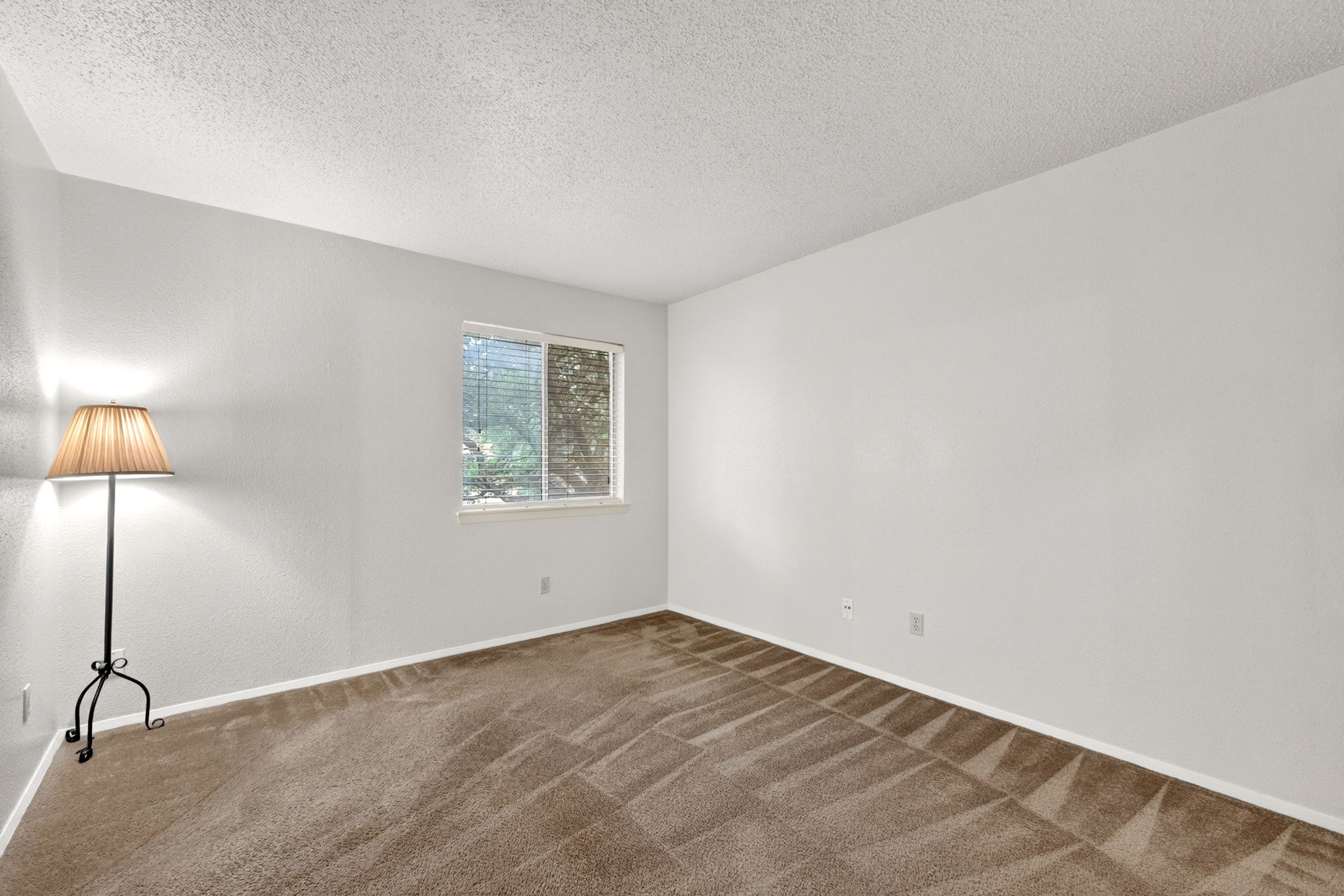 8210 Bent Tree Road, Unit 256 Austin, TX 78759 - Photo 12 of 29 an empty room with a lamp and a window