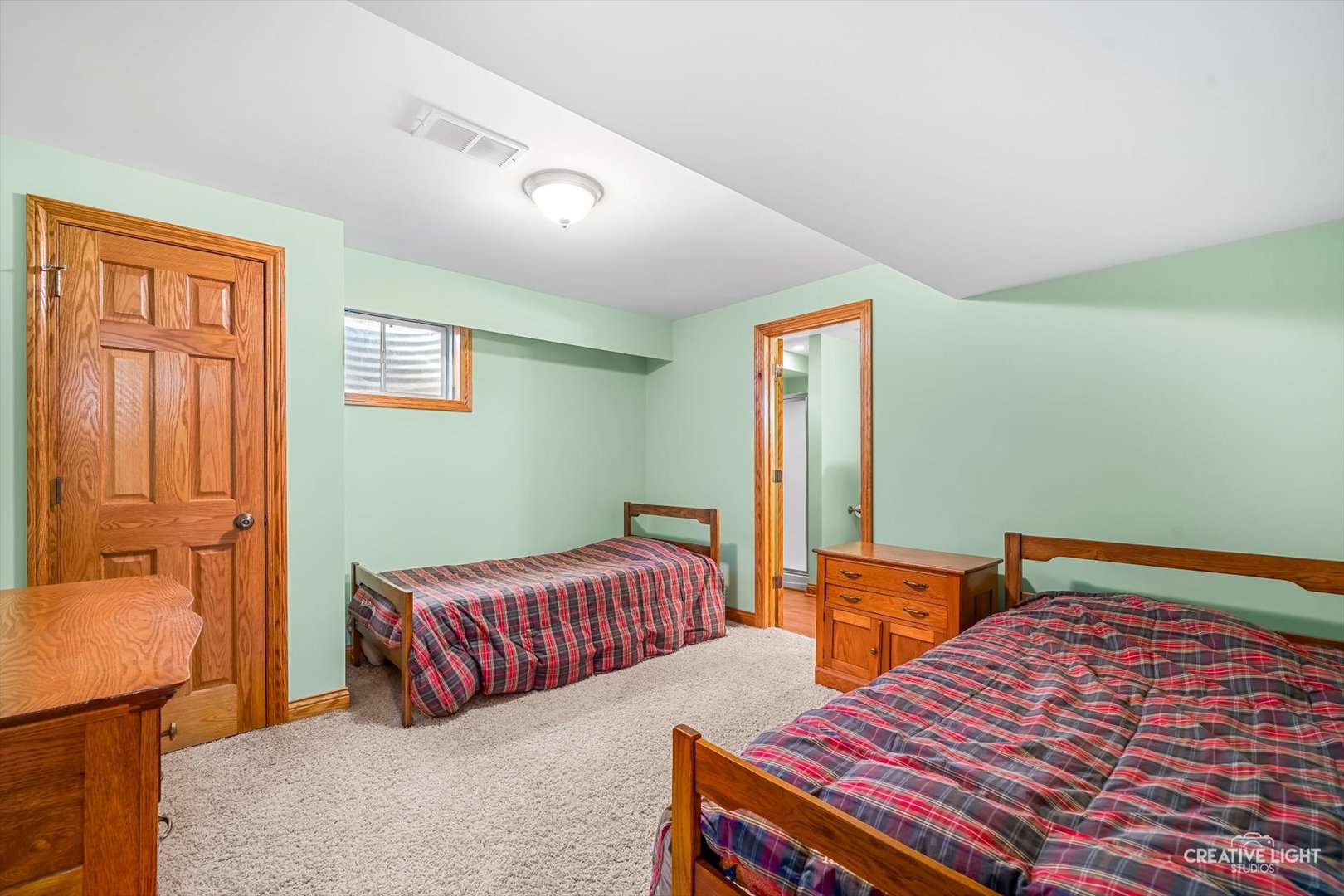 714 East Knights Road Sandwich, IL 60548 - Photo 22 of 33 a bedroom with two beds and a dresser next to a window
