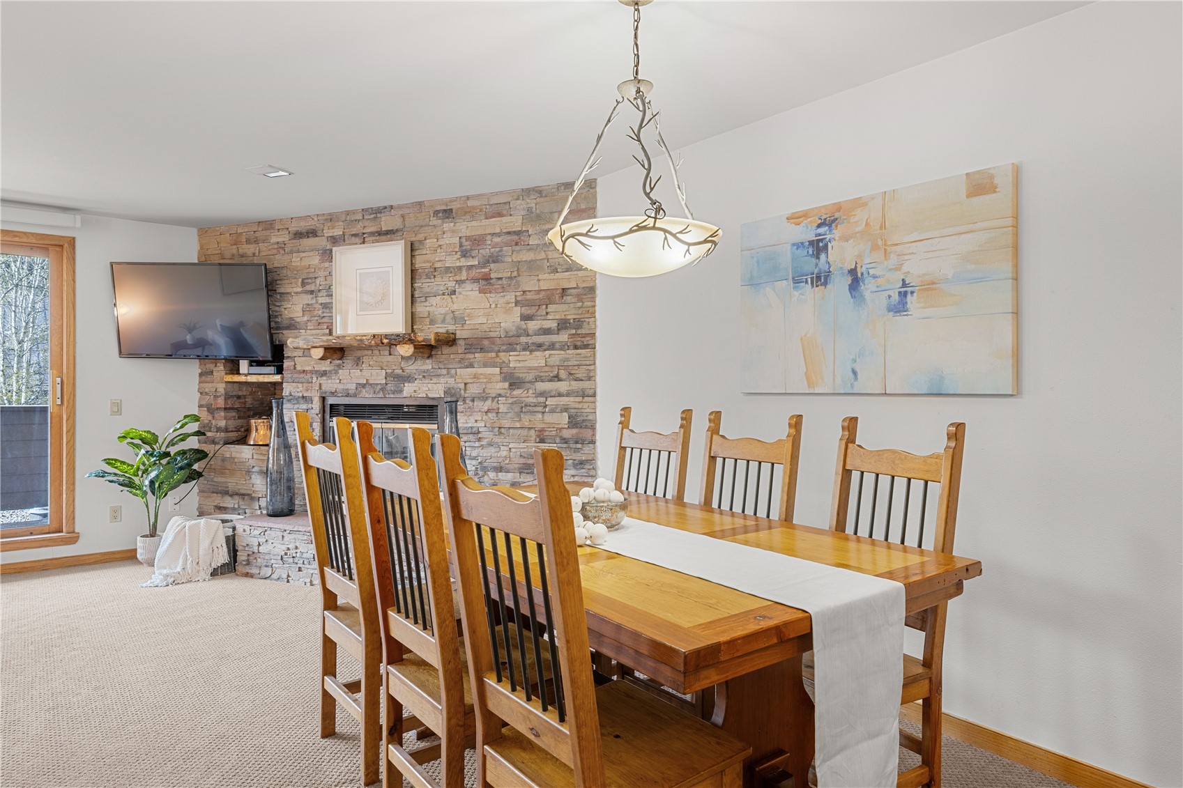 22804 Highway 6, Unit 102 Keystone, CO 80435 - Photo 9 of 34 a view of a dining room with furniture wooden floor and a chandelier