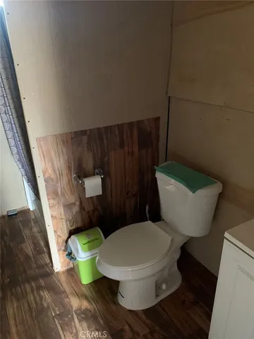 a white toilet sitting next to a small bathroom