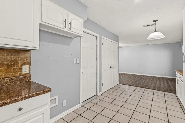 a view of a livingroom with wooden floor and staircase