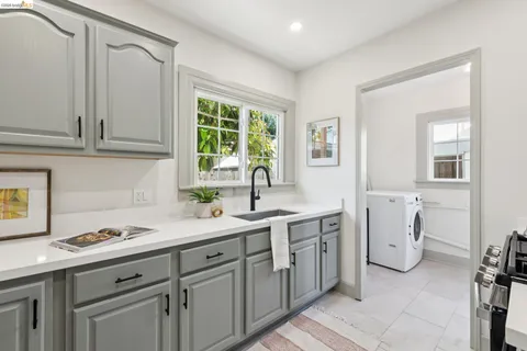 a kitchen with a sink cabinets and window