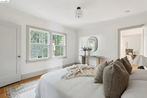 a bedroom with a bed and a lamp on dresser