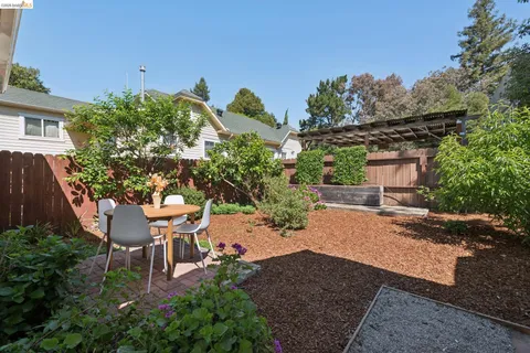 a view of a patio with table and chairs and potted plants