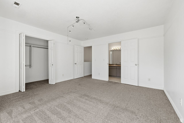 977 East 100 South Payson, UT 84651 - Photo 11 of 19 Unfurnished bedroom with a closet, light carpet, and ensuite bathroom