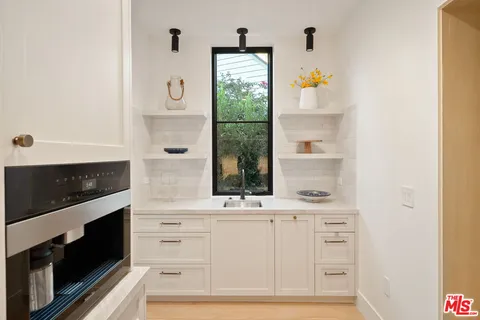 a dining room with furniture a chandelier and wooden floor