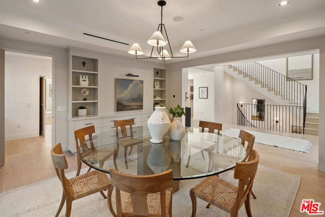 10444 Charing Cross Road Los Angeles, CA 90024 - Photo 23 of 74 a dining room with furniture a chandelier and wooden floor