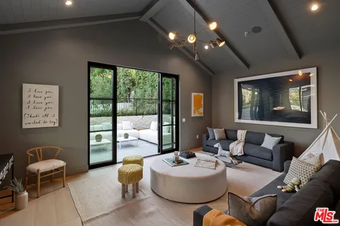 a bedroom with a bed a chair and a window