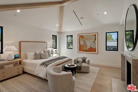 a living room with furniture and view of kitchen
