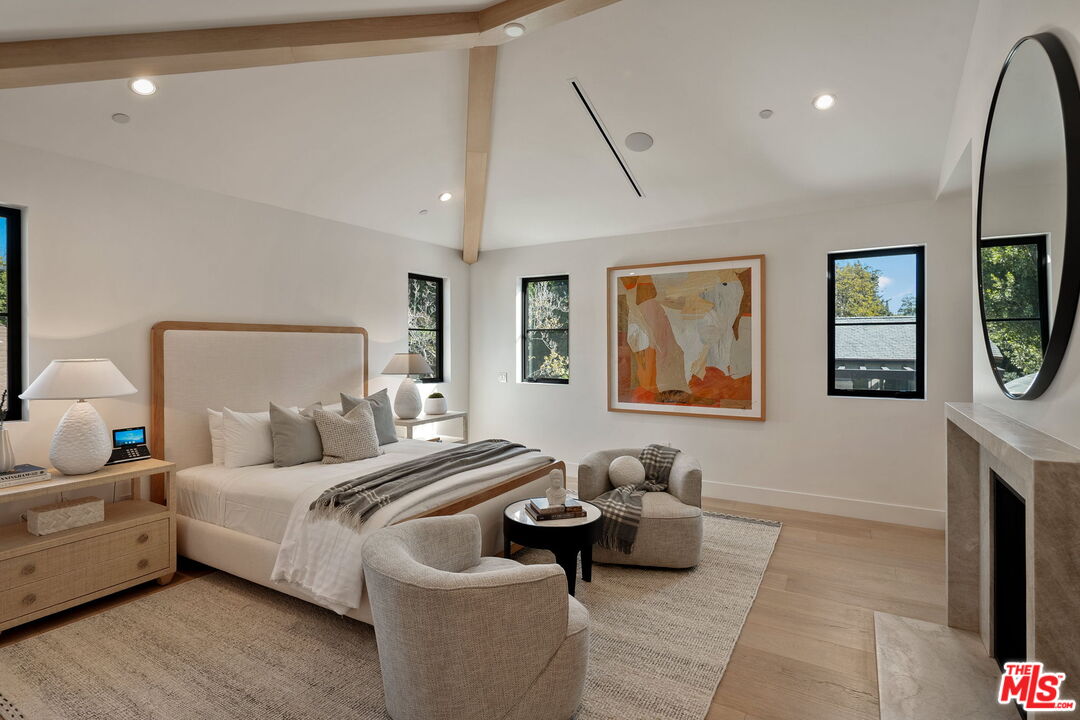 10444 Charing Cross Road Los Angeles, CA 90024 - Photo 32 of 74 a bedroom with furniture and a fireplace