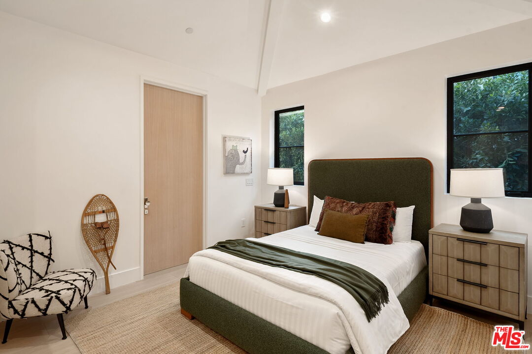 10444 Charing Cross Road Los Angeles, CA 90024 - Photo 41 of 74 a bedroom with a bed a chair and a window