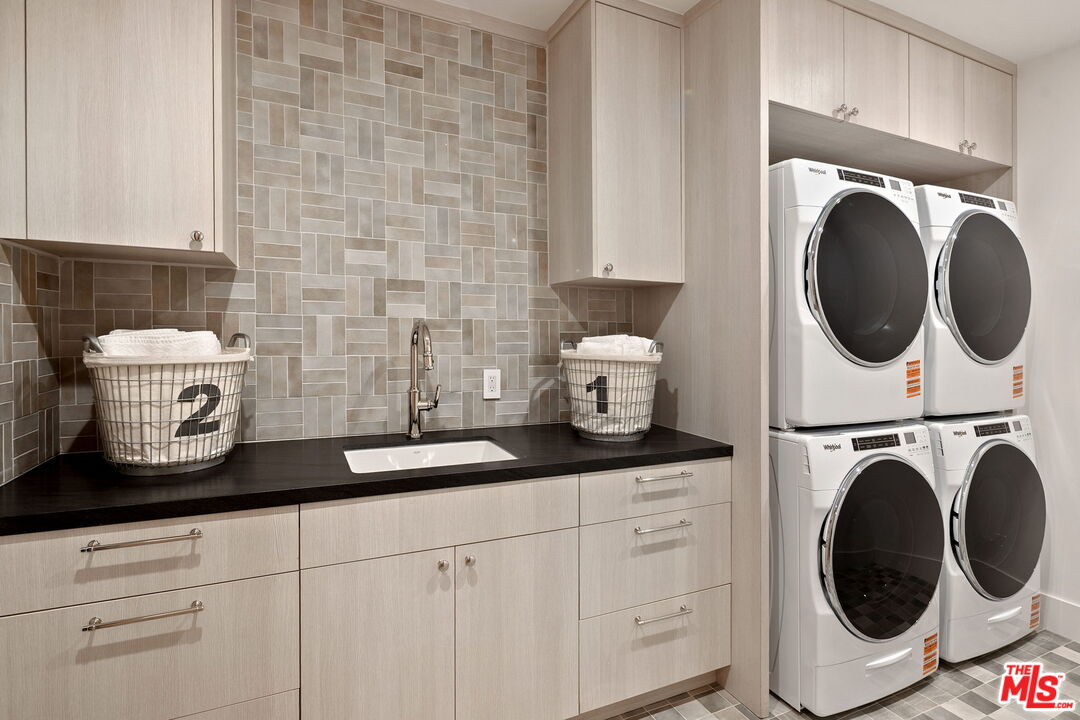 10444 Charing Cross Road Los Angeles, CA 90024 - Photo 56 of 74 a close view of a utility room with dryer and washer