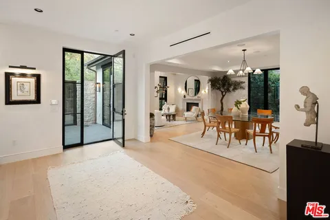 a view of a livingroom with furniture and tables in room