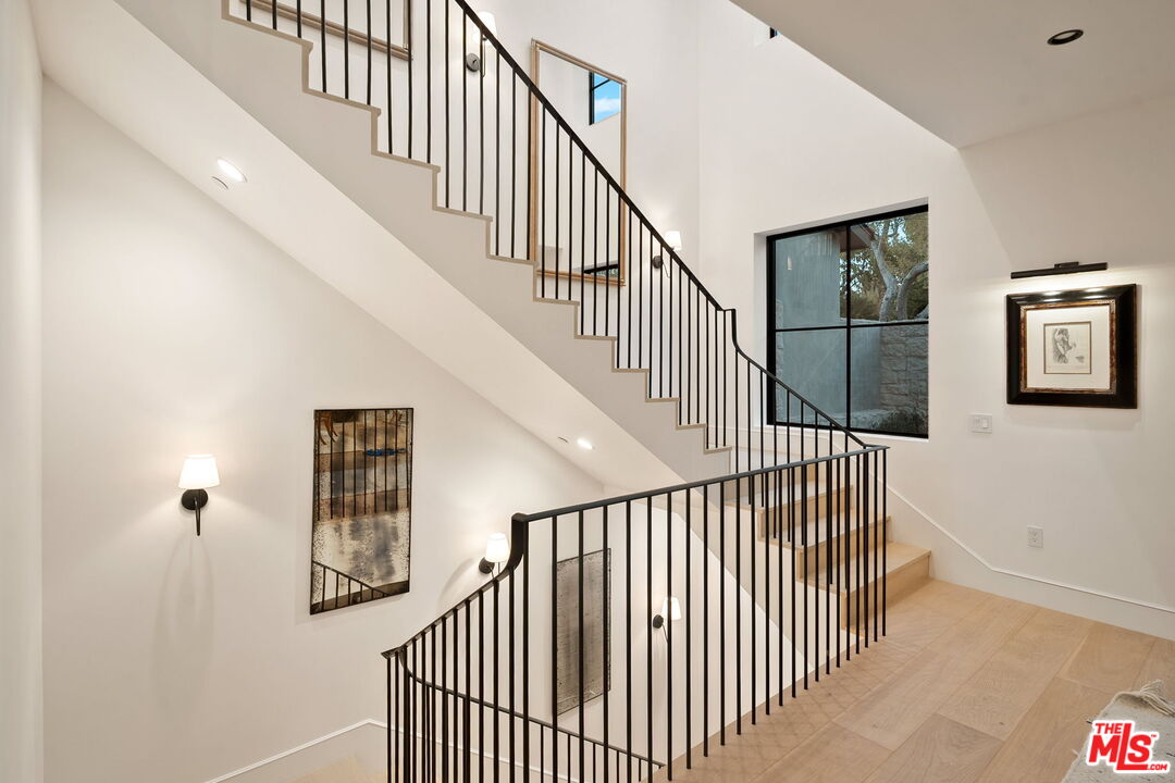 10444 Charing Cross Road Los Angeles, CA 90024 - Photo 70 of 74 a view of staircase with railing and white walls