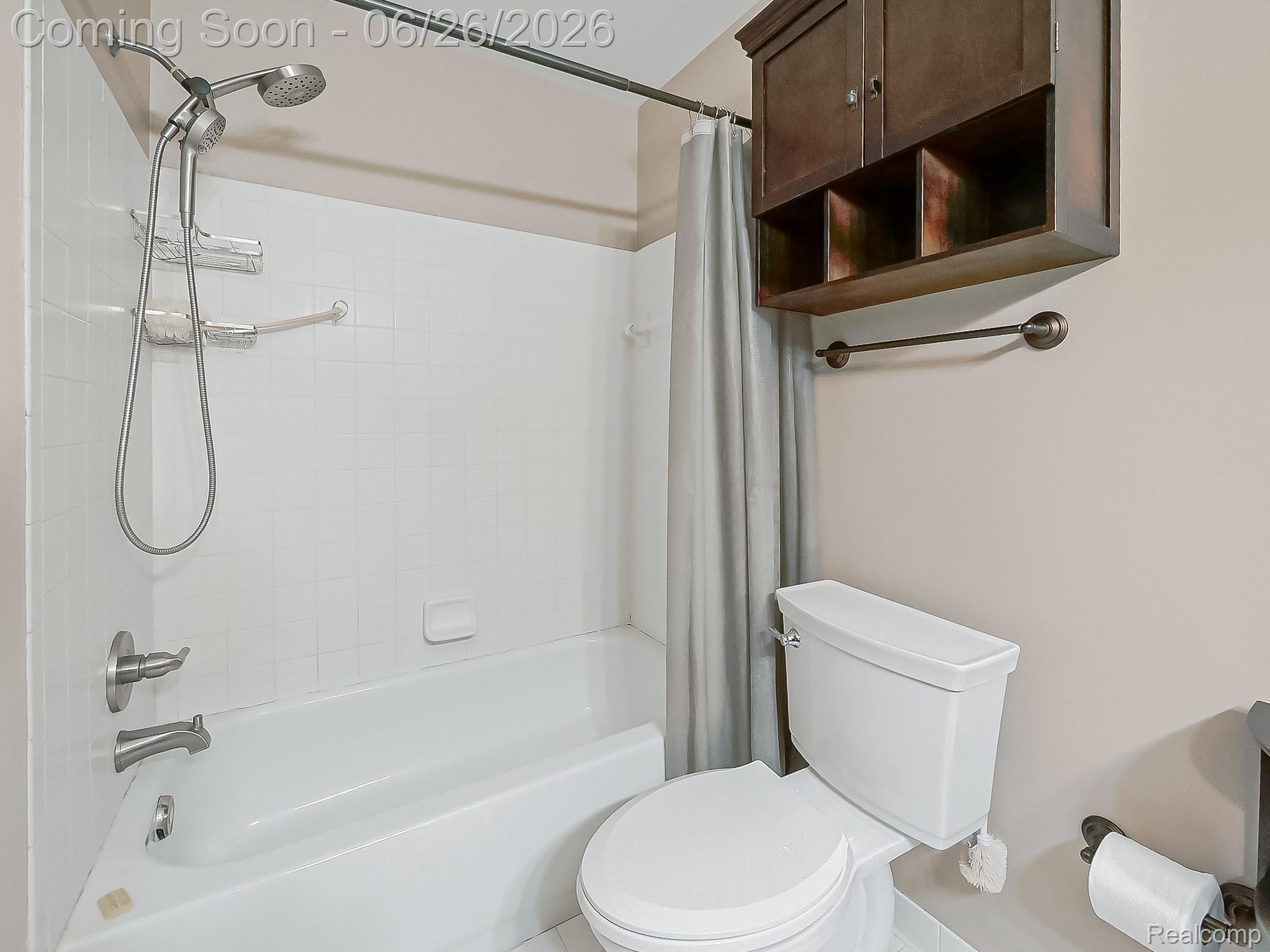 160 Pine Tree Ridge, Unit 3 Waterford, MI 48327 - Photo 8 of 26 Tub and shower combination featuring white tiled surround and brushed nickel fixtures