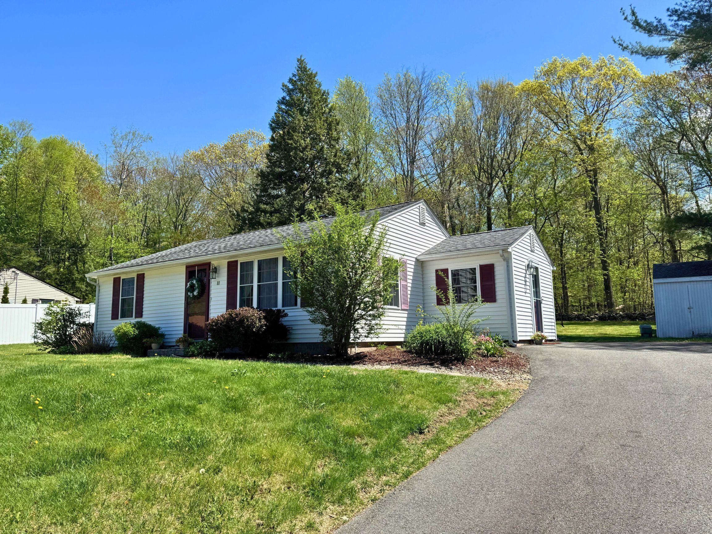a front view of house with yard and green space