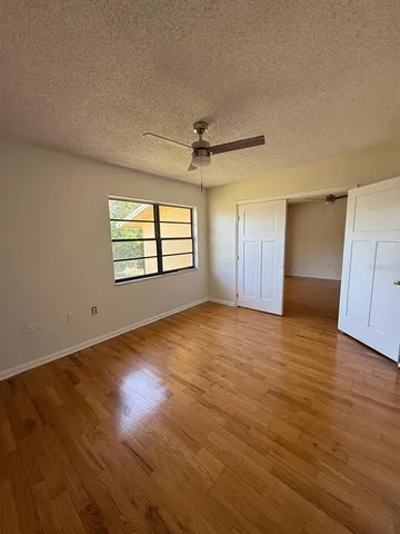 a bathroom with a granite countertop sink a toilet and bathtub