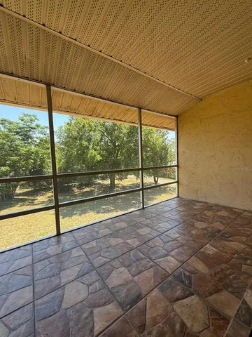 a view of swimming pool with outdoor seating and a garden