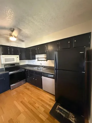 a kitchen with granite countertop stainless steel appliances and wooden cabinets