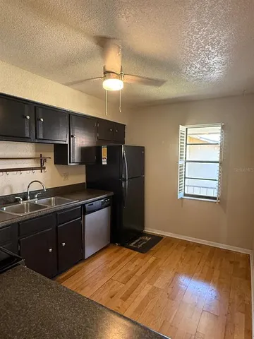 a view of a hallway with wooden floor and closet