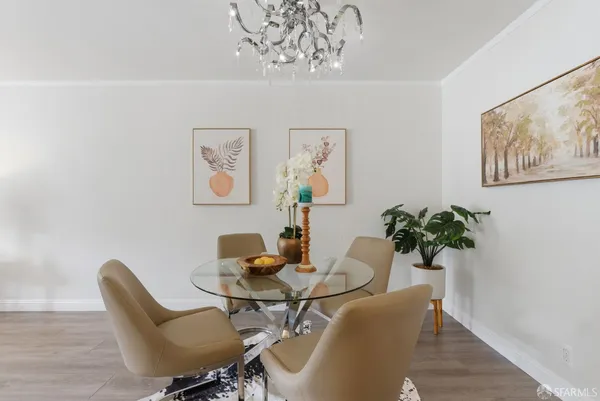 a dining room with furniture and wooden floor