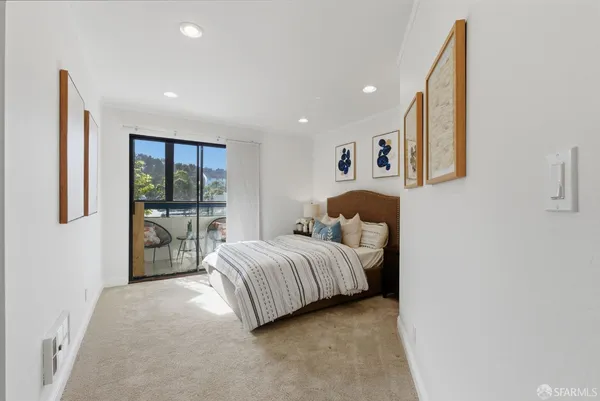 a spacious bedroom with a bed and glass wall