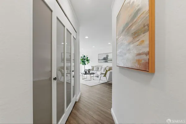 a view of living room with furniture and wooden floor