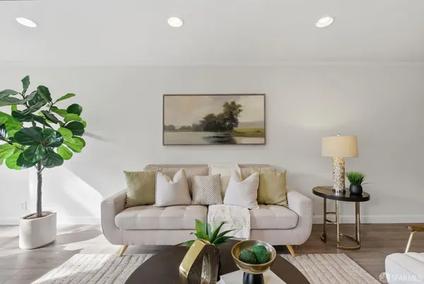 a living room with furniture and a potted plant