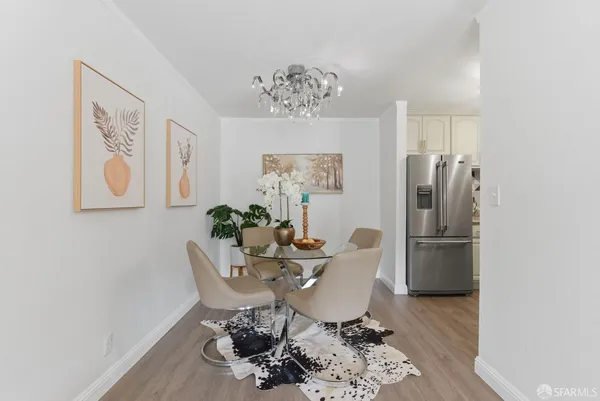 a dining room with furniture a rug and wooden floor