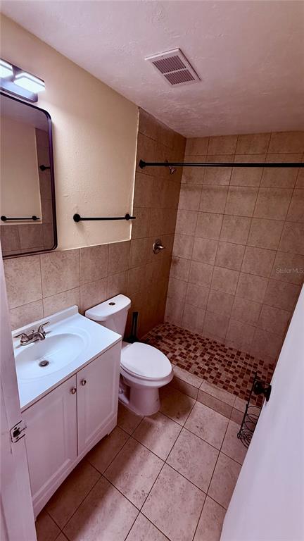 6519 West Newberry Road, Unit 206 Gainesville, FL 32605 - Photo 10 of 14 a bathroom with a sink a toilet and shower