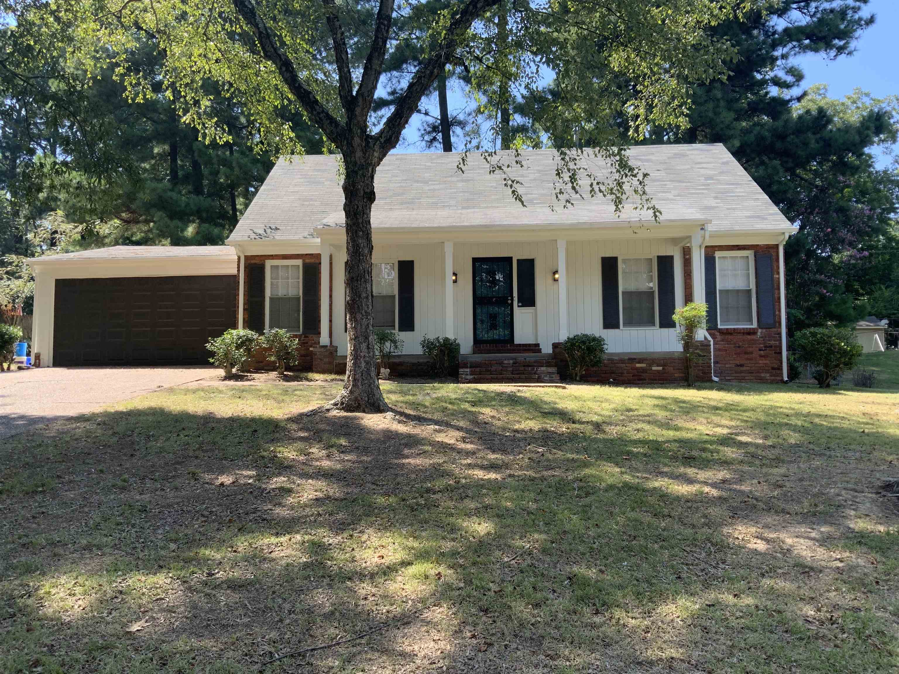 2965 Falkirk Road Memphis, TN 38128 - Photo 1 of 27 a front view of a house with a garden and patio