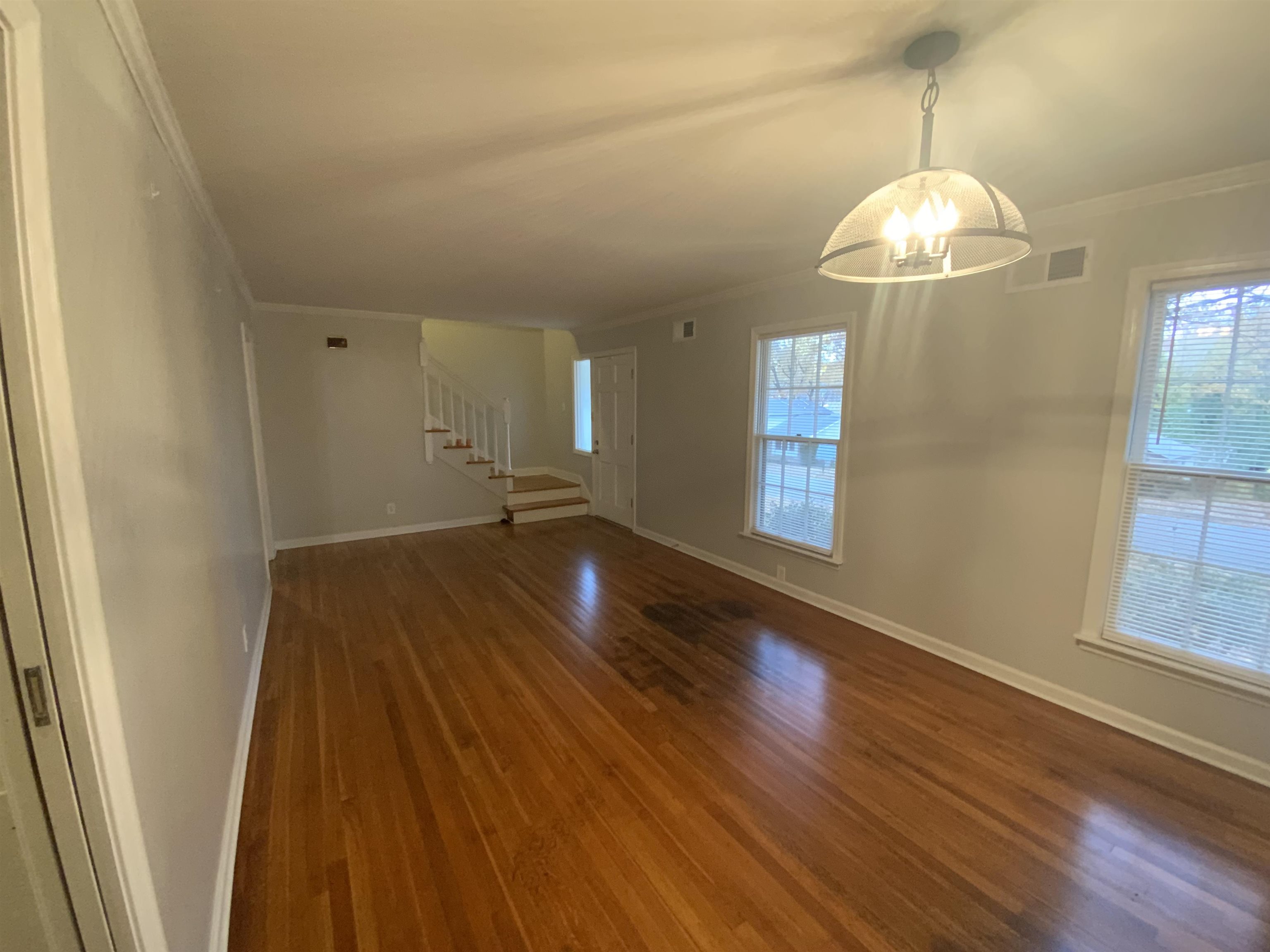 2965 Falkirk Road Memphis, TN 38128 - Photo 2 of 27 a view of an empty room with wooden floor and a window