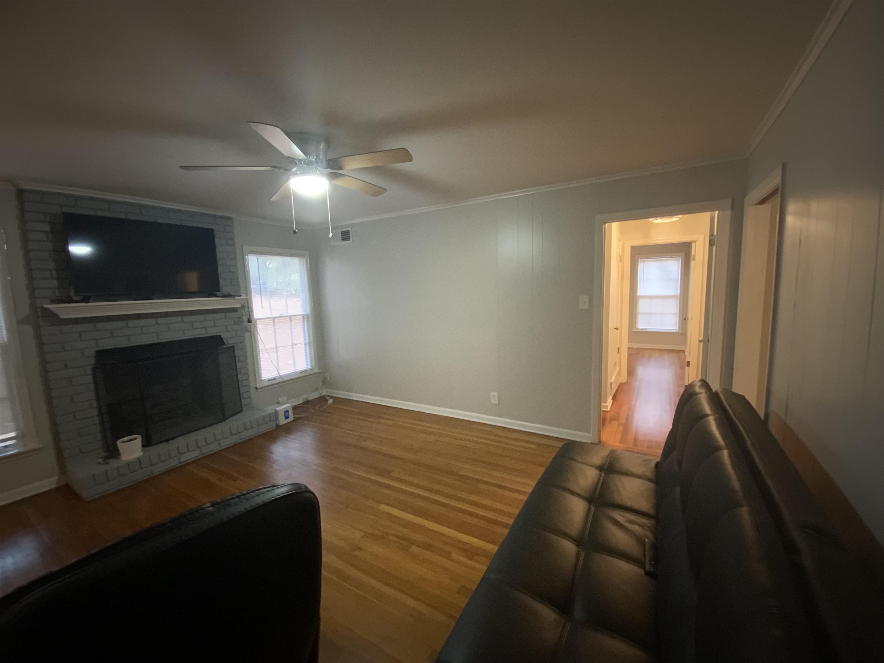 2965 Falkirk Road Memphis, TN 38128 - Photo 7 of 27 a view of empty room with wooden floor and fireplace