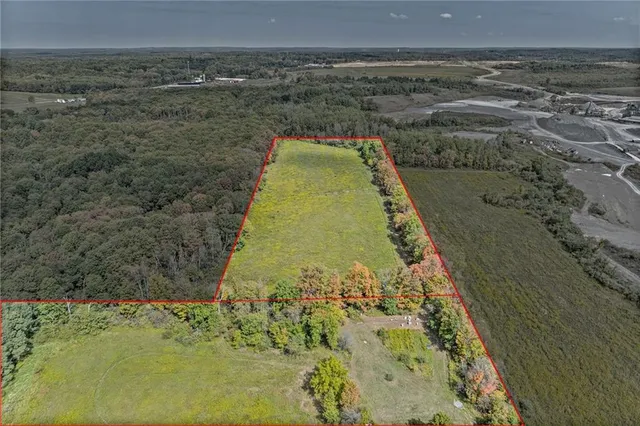 a view of a field of grass and trees