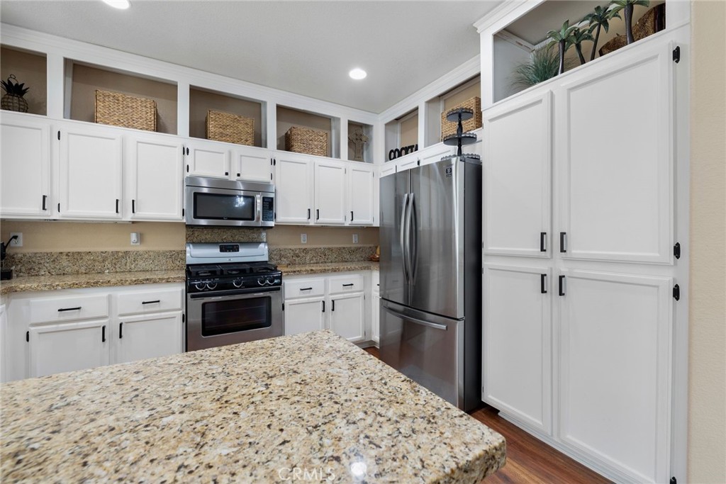 17821 Morning Rock Circle Riverside, CA 92503 - Photo 17 of 47 a kitchen with stainless steel appliances granite countertop a refrigerator sink and stove
