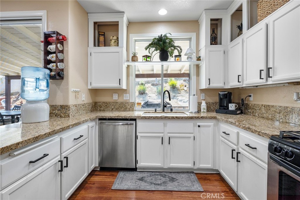 17821 Morning Rock Circle Riverside, CA 92503 - Photo 18 of 47 a kitchen with granite countertop a white cabinets and window