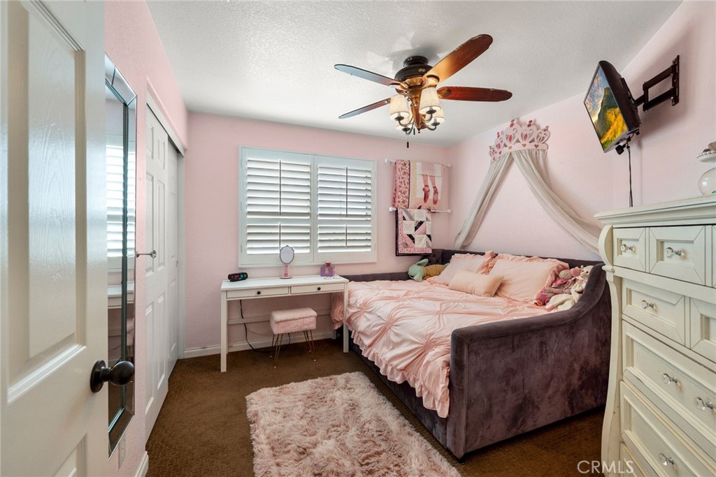 17821 Morning Rock Circle Riverside, CA 92503 - Photo 24 of 47 a bedroom with a bed and a chandelier