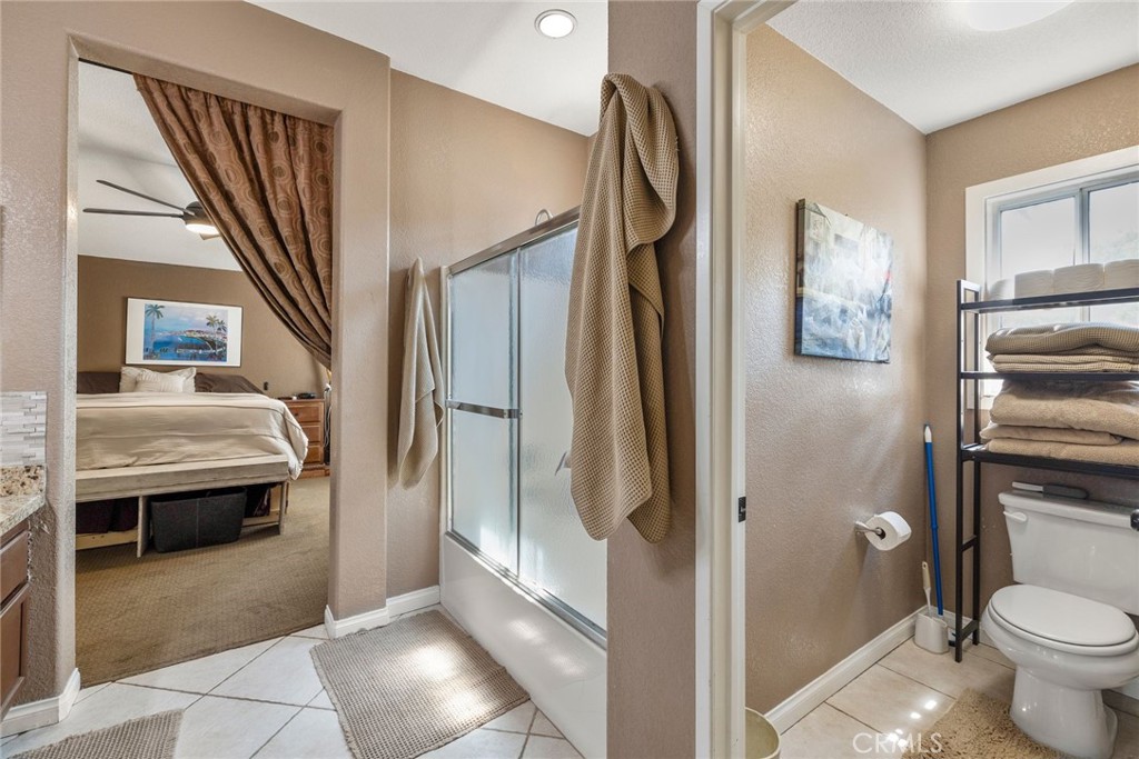 17821 Morning Rock Circle Riverside, CA 92503 - Photo 29 of 47 a bathroom with a granite countertop sink toilet and shower