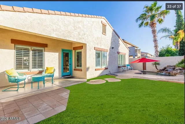 a view of a house with backyard porch and sitting area