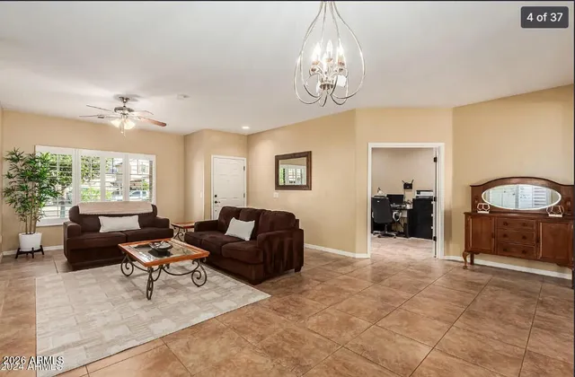 a living room with furniture and a chandelier