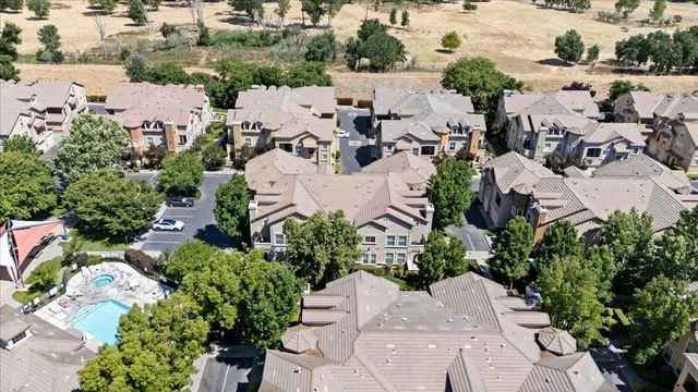 an aerial view of a house with a yard