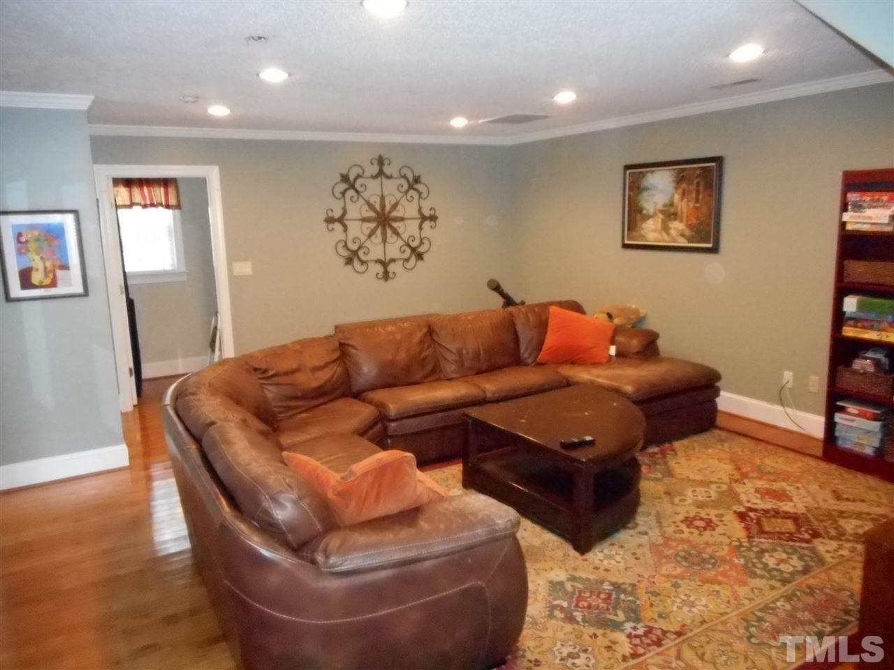 7920 Sutterton Court Raleigh, NC 27615 - Photo 11 of 22 a living room with furniture and wooden floor