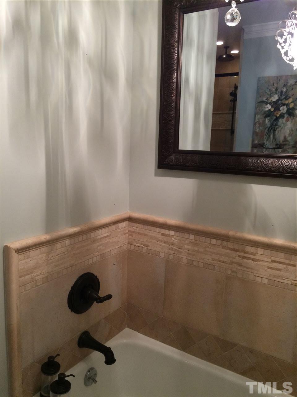 7920 Sutterton Court Raleigh, NC 27615 - Photo 20 of 22 a bathroom with a shower