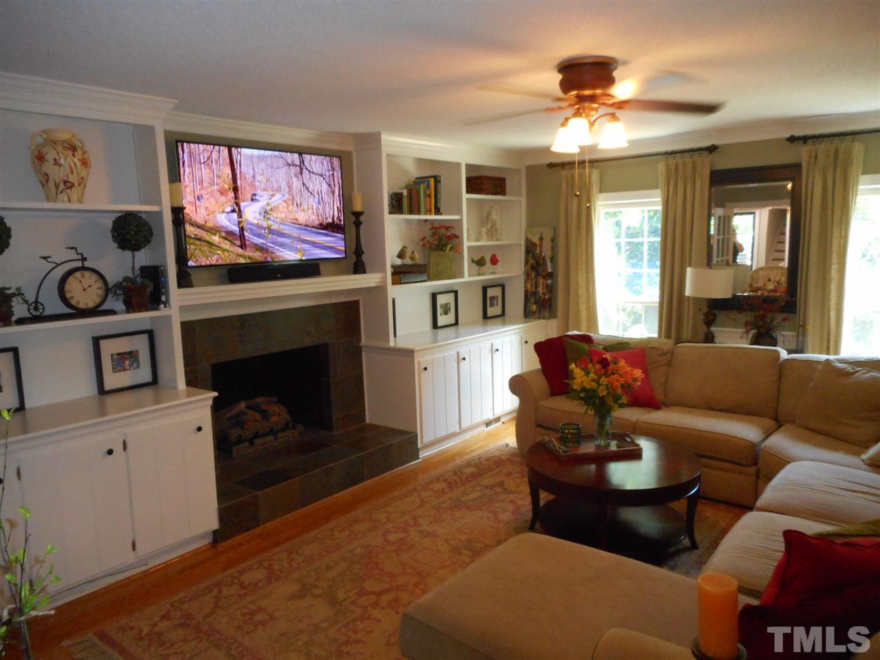 7920 Sutterton Court Raleigh, NC 27615 - Photo 21 of 22 a living room with furniture and a fireplace