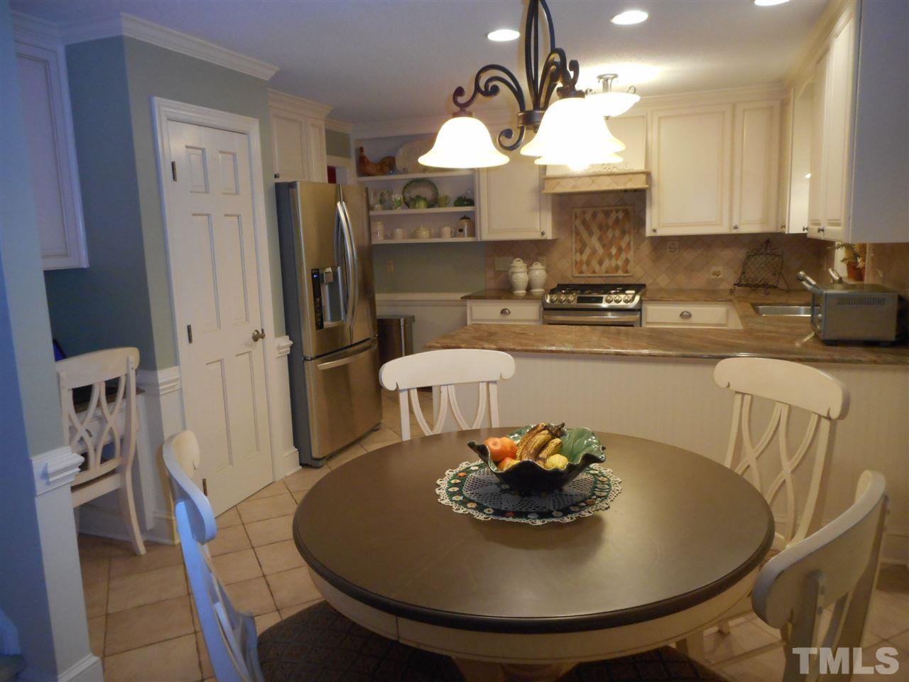 7920 Sutterton Court Raleigh, NC 27615 - Photo 5 of 22 a kitchen with a table and chairs