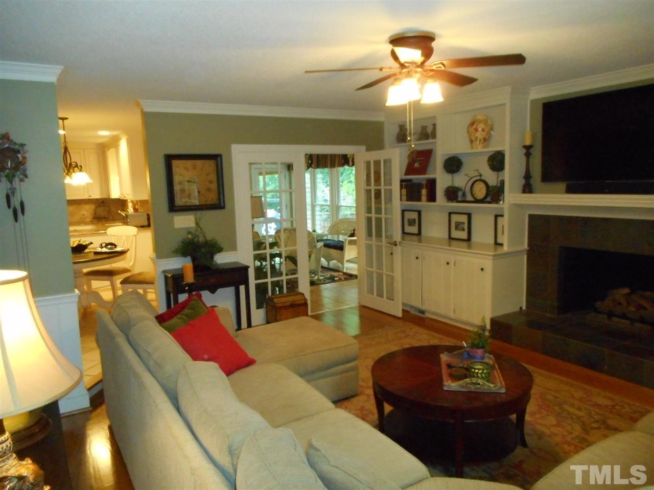 7920 Sutterton Court Raleigh, NC 27615 - Photo 6 of 22 a living room with furniture and a fireplace