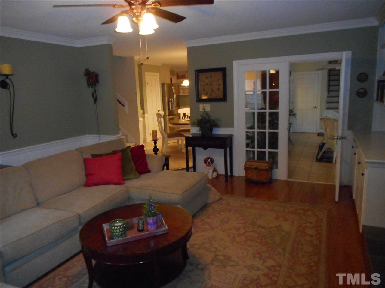 7920 Sutterton Court Raleigh, NC 27615 - Photo 7 of 22 a living room with furniture a chandelier and a dining table