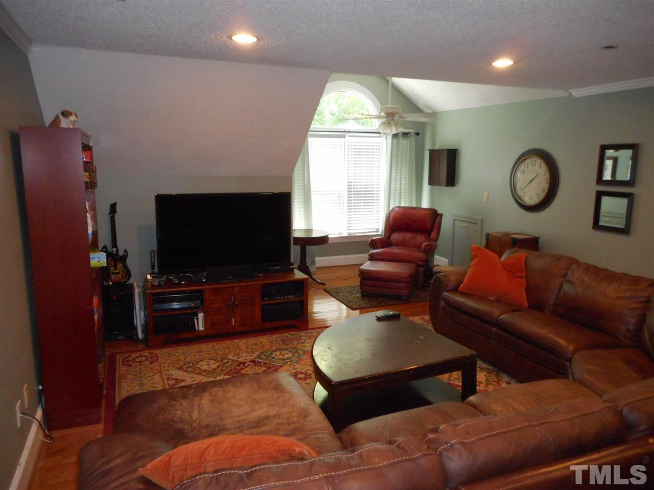 7920 Sutterton Court Raleigh, NC 27615 - Photo 10 of 22 a living room with furniture and a flat screen tv