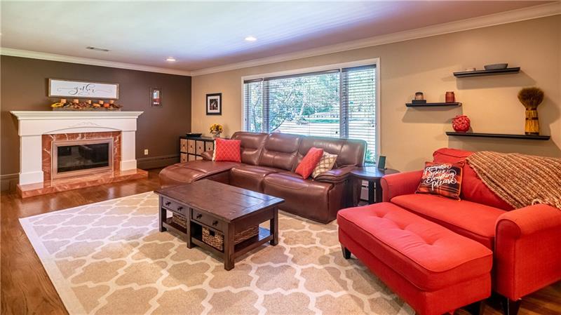 231 Brown Road Wexford, PA 15090 - Photo 5 of 25 Very Large Living Room with gleaming hardwood floors throughout home. Light and Bright with the large window. Marble Framed Log Fireplace to warm you in the winters.
